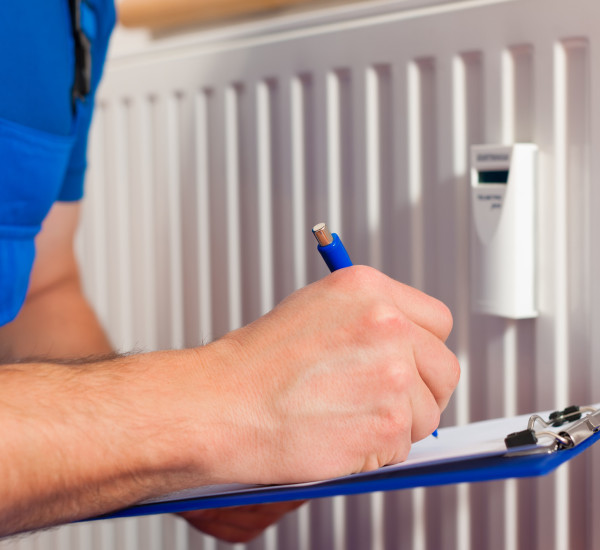 An image of an EGP Plumber engineer carrying out radiator checks